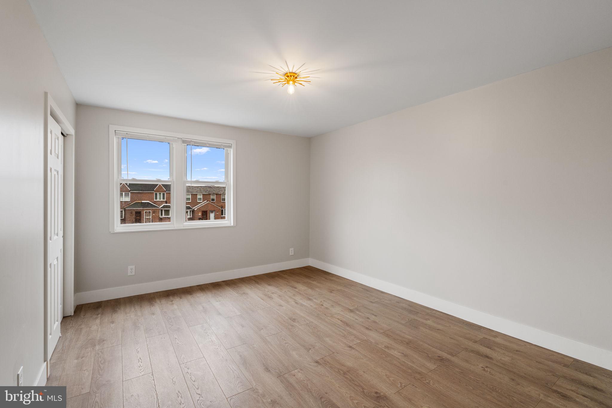 8546 Forrest Avenue Philadelphia, PA 19150 - Photo 33 of 56 a view of an empty room with wooden floor and a window