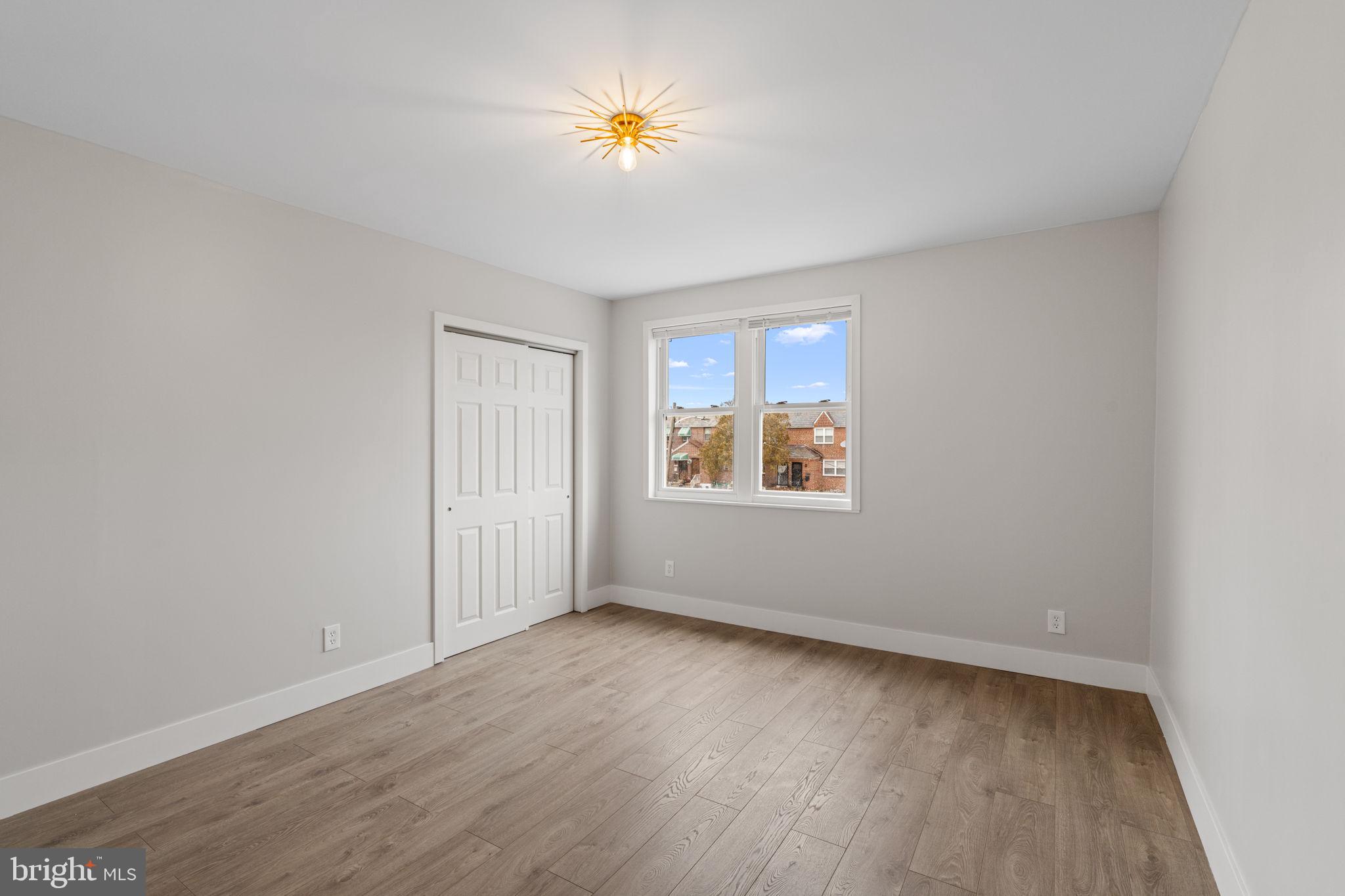 8546 Forrest Avenue Philadelphia, PA 19150 - Photo 36 of 56 an empty room with a window and a ceiling fan