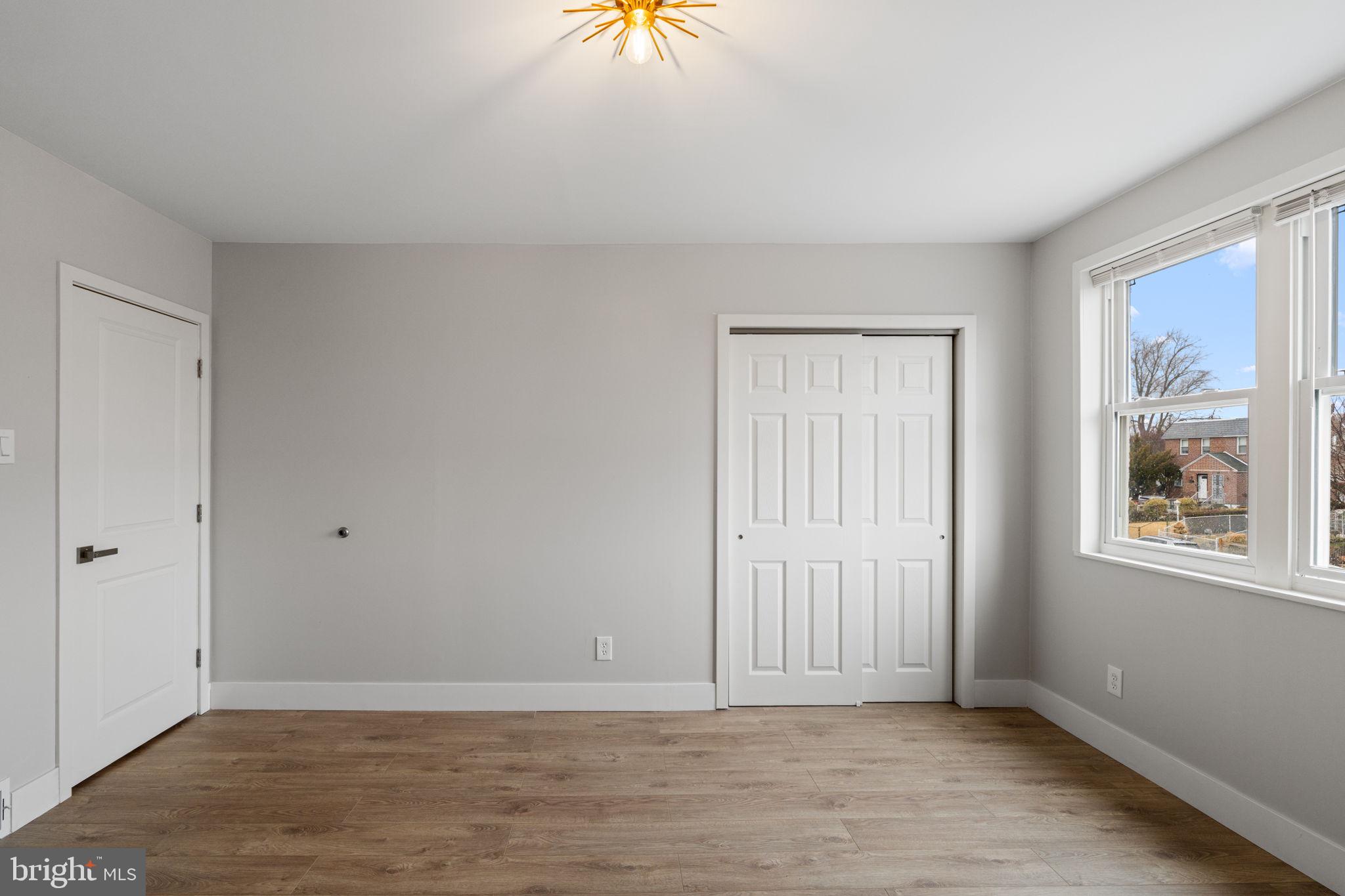 8546 Forrest Avenue Philadelphia, PA 19150 - Photo 37 of 56 a view of an empty room with window and wooden floor