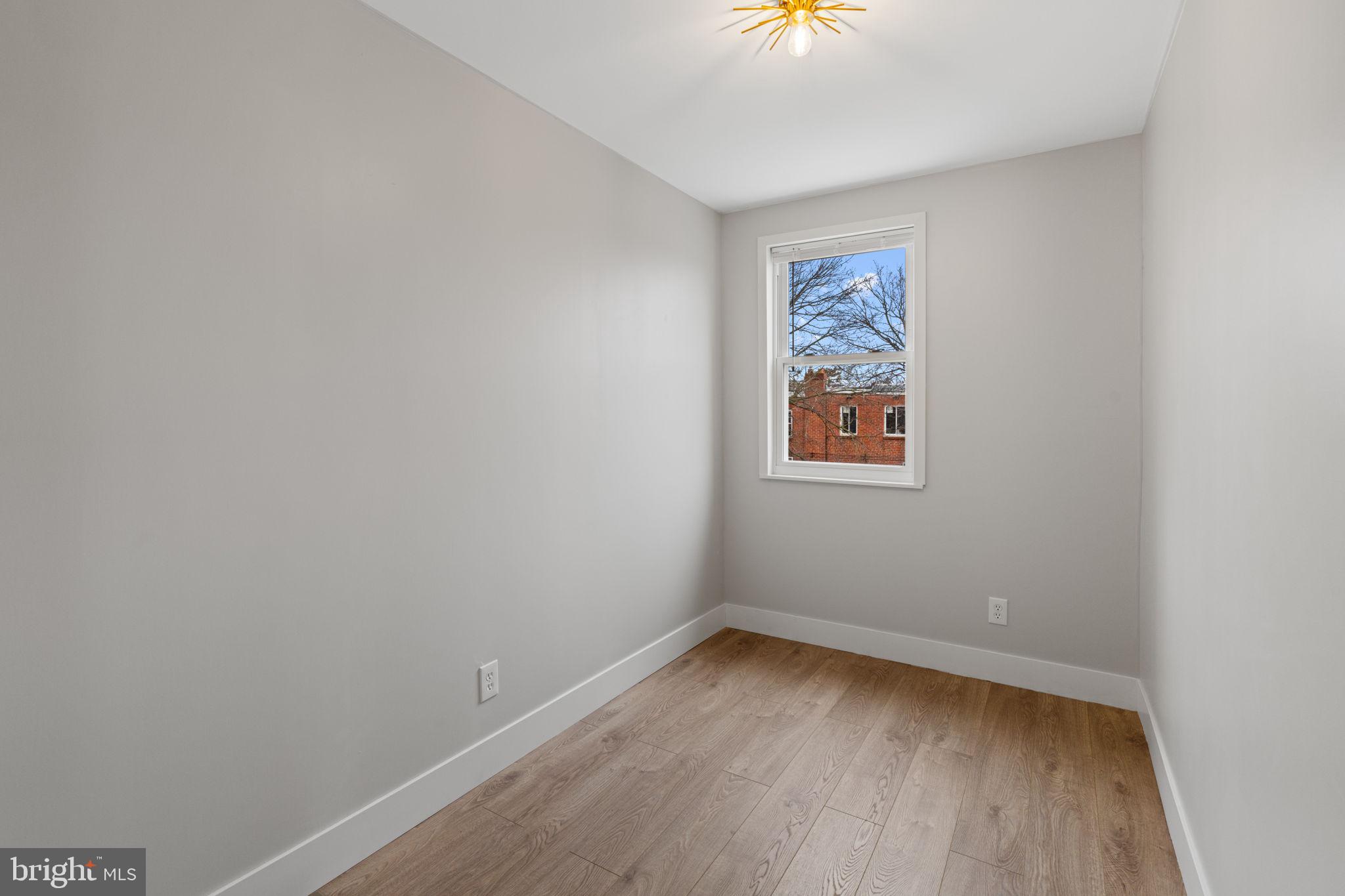 8546 Forrest Avenue Philadelphia, PA 19150 - Photo 38 of 56 an empty room with a window and wooden floor