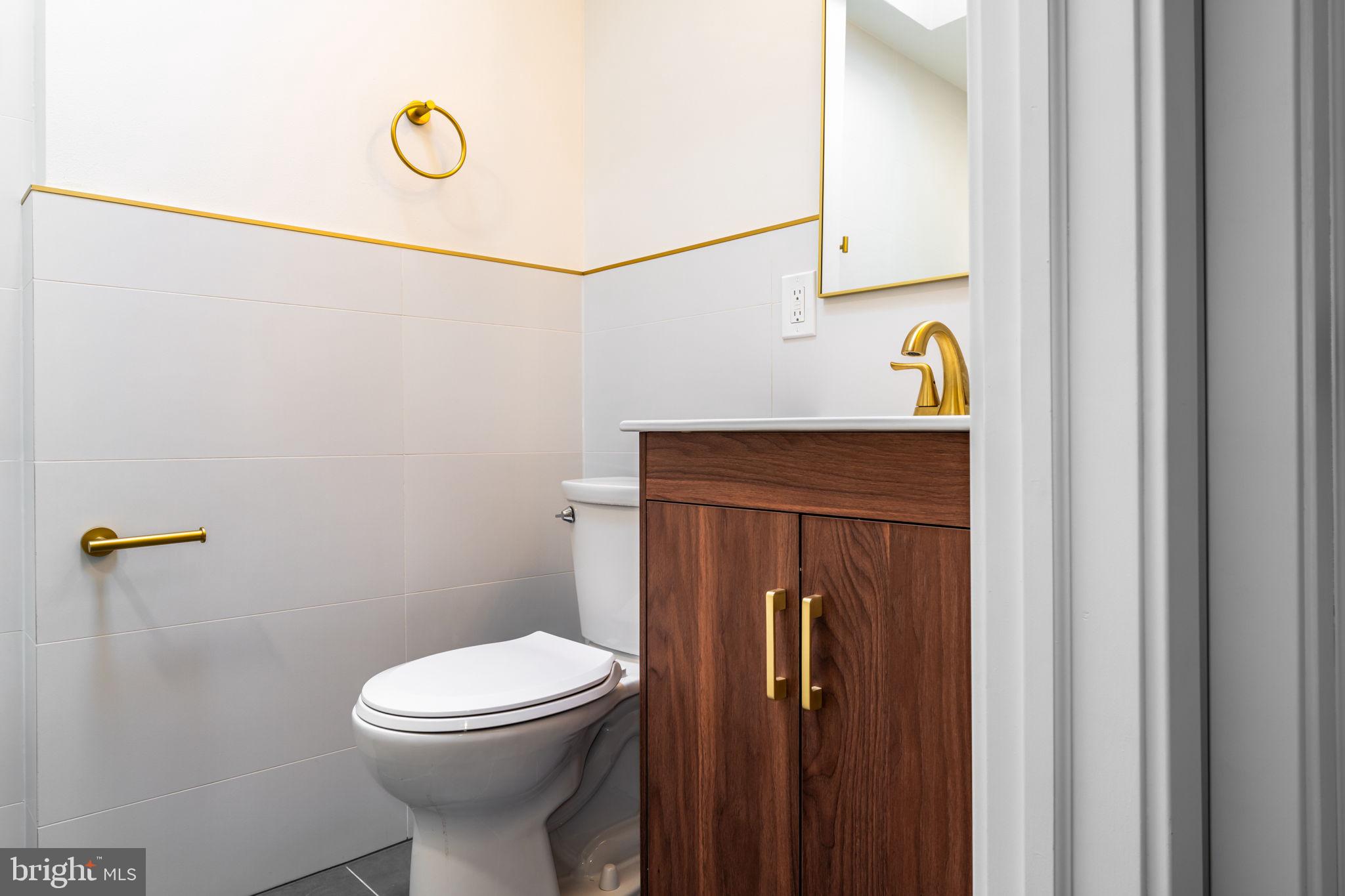 8546 Forrest Avenue Philadelphia, PA 19150 - Photo 50 of 56 a bathroom with a sink a toilet and vanity