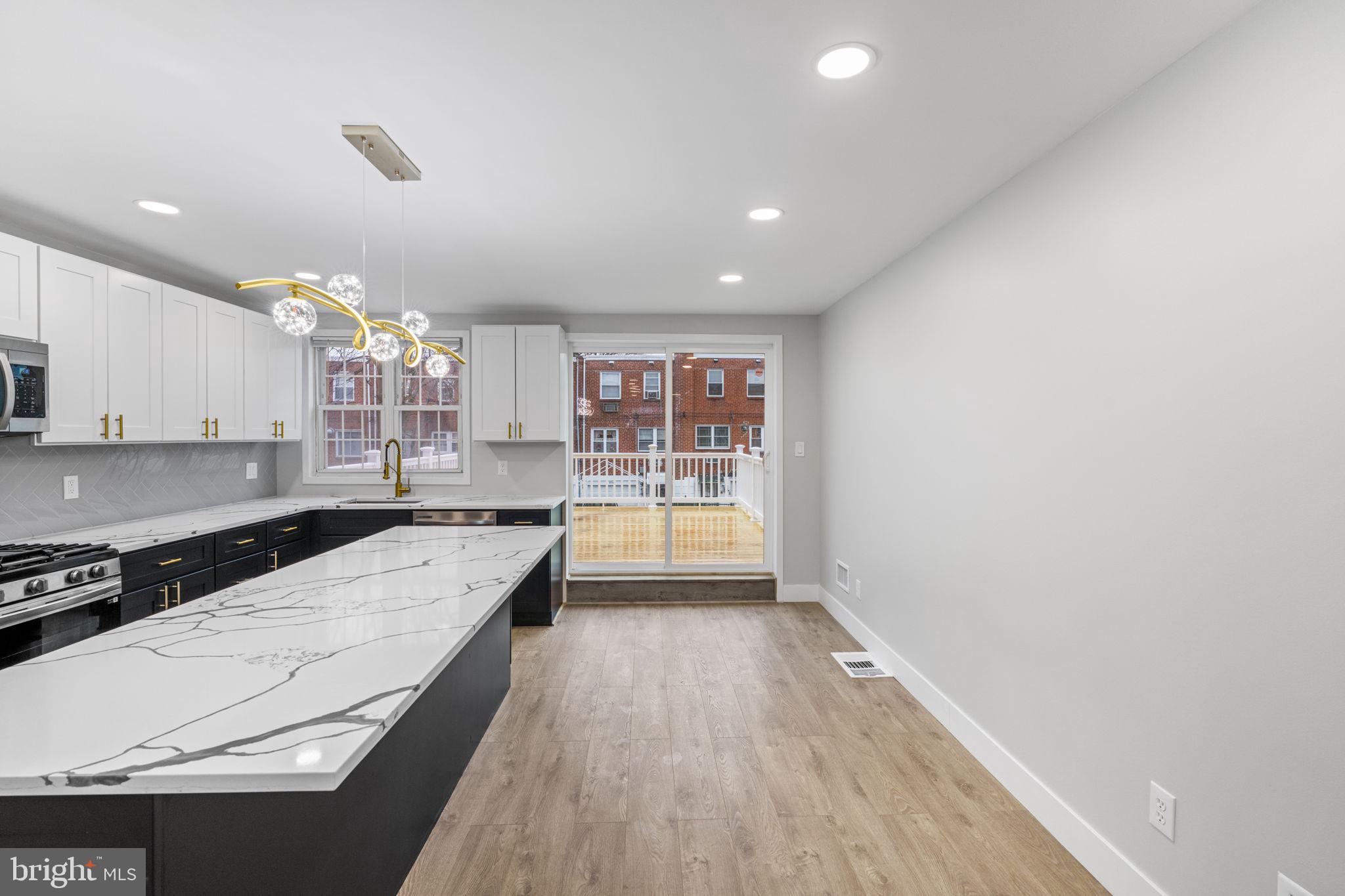 8546 Forrest Avenue Philadelphia, PA 19150 - Photo 9 of 56 a kitchen with a stove a sink and a refrigerator