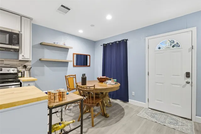 a kitchen with stainless steel appliances kitchen island granite countertop a sink and a refrigerator