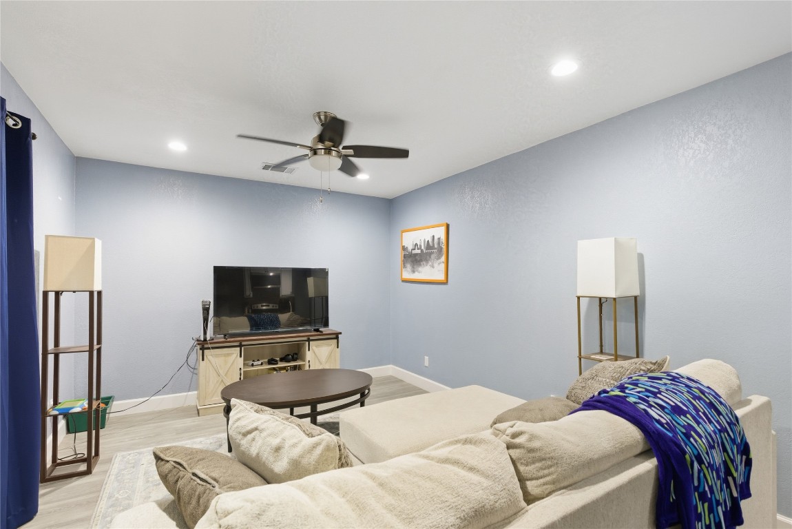 5401 Agua Caliente Cove, Unit B Austin, TX 78744 - Photo 15 of 26 a living room with furniture and a flat screen tv