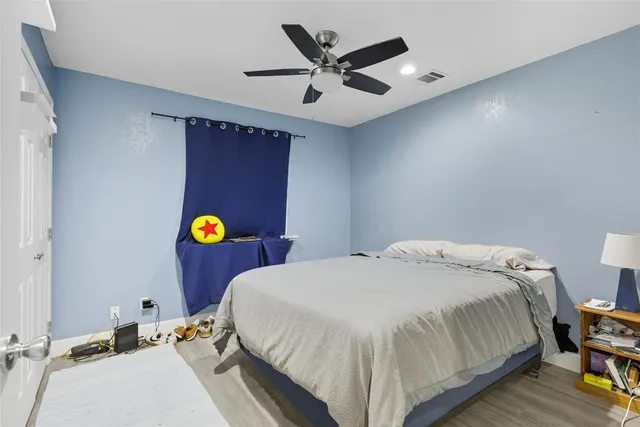 a bedroom with a bed and ceiling fan