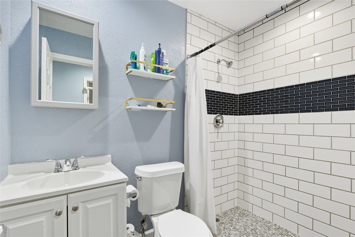 5401 Agua Caliente Cove, Unit B Austin, TX 78744 - Photo 17 of 26 a bathroom with a sink toilet and shower
