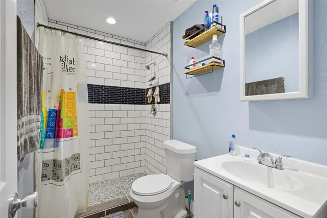 a bathroom with a sink toilet and shower