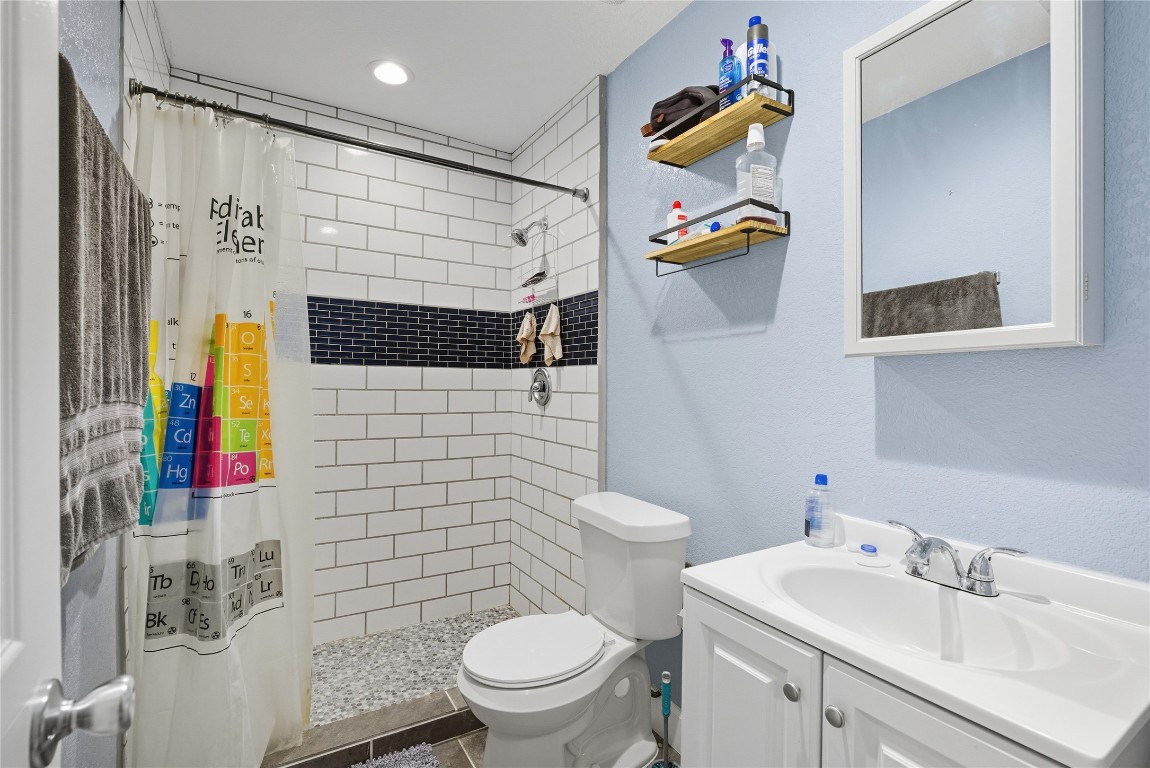 5401 Agua Caliente Cove, Unit B Austin, TX 78744 - Photo 18 of 26 a bathroom with a sink toilet and shower