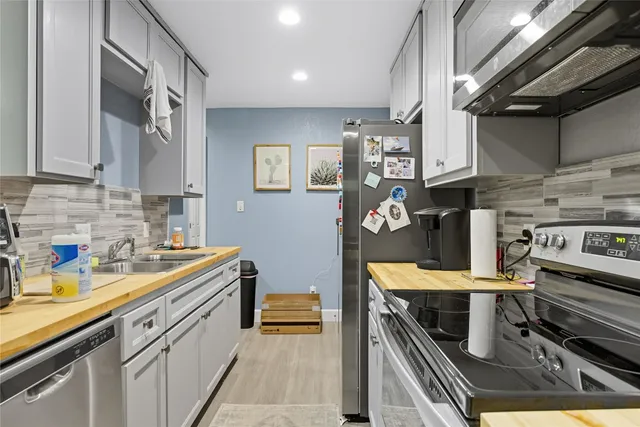 a kitchen with stainless steel appliances granite countertop a stove and a sink