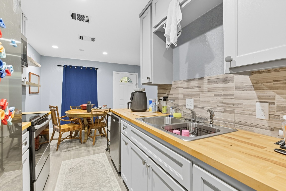 5401 Agua Caliente Cove, Unit B Austin, TX 78744 - Photo 9 of 26 a kitchen with a sink and cabinets
