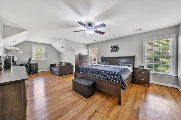 a room with a bed and a television