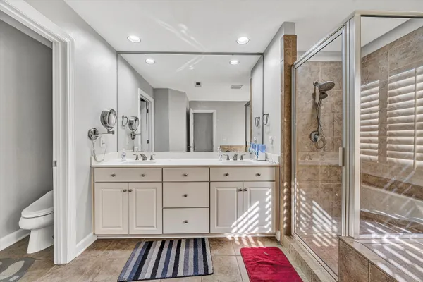a bathroom with a sink toilet and shower