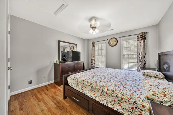 a open kitchen with stainless steel appliances granite countertop a stove top oven a sink dishwasher a dining table and chairs with wooden floor