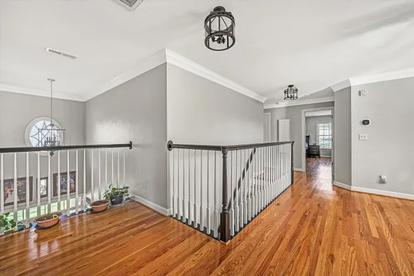 a large kitchen with stainless steel appliances kitchen island granite countertop a large kitchen island a stove a refrigerator a sink dishwasher a dining table and chairs with wooden floor