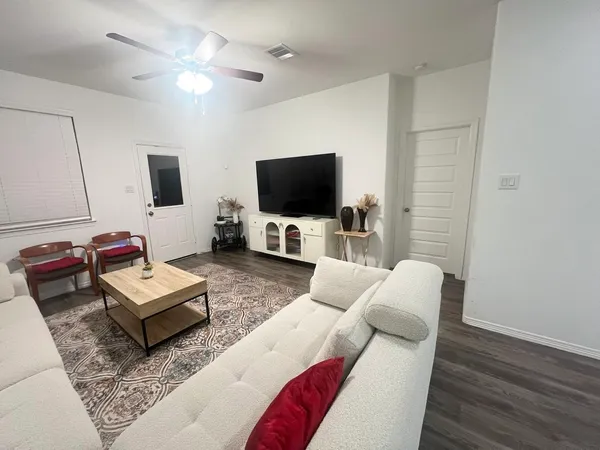 a living room with furniture and a flat screen tv