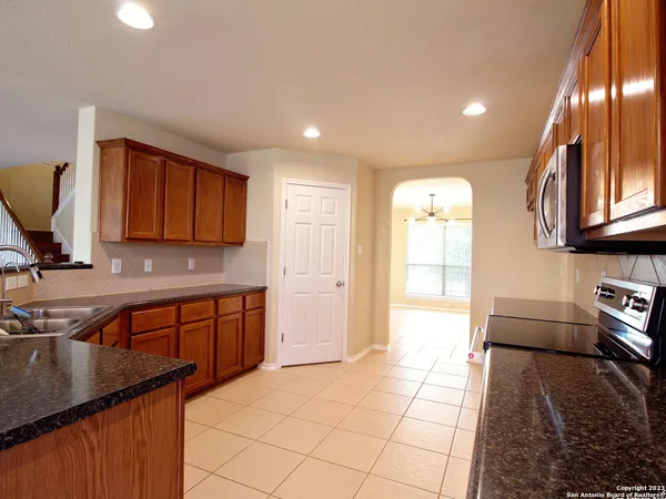 a kitchen with stainless steel appliances granite countertop a sink stove and cabinets