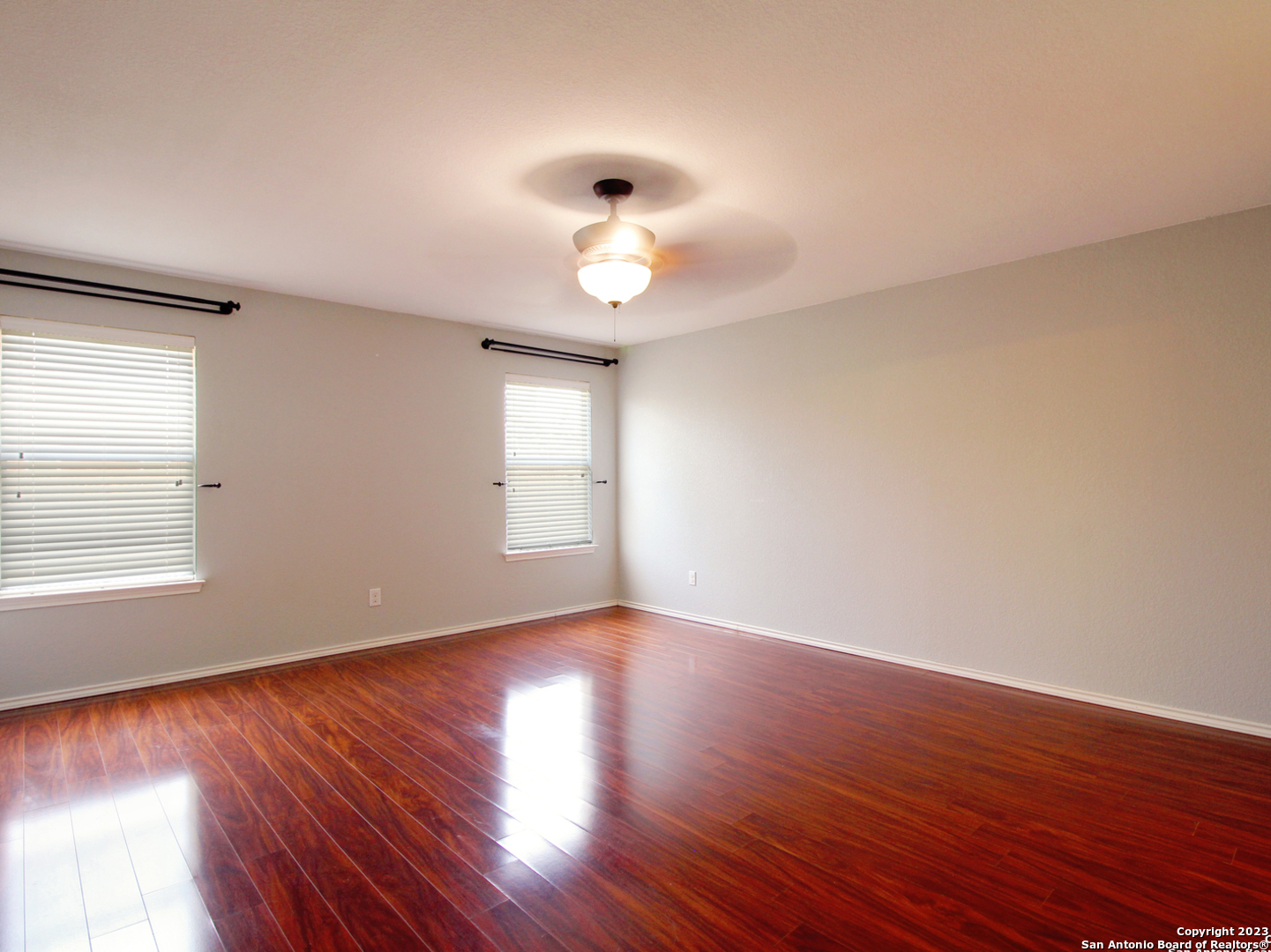 9627 Mediator Run Converse, TX 78109 - Photo 17 of 41 a view of an empty room with wooden floor and a window