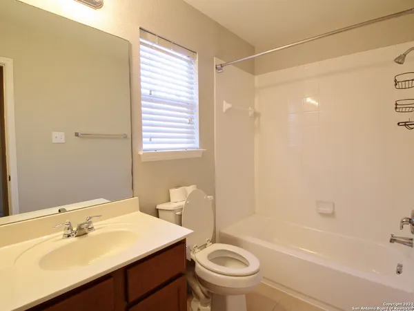 a bathroom with a sink mirror toilet and bathtub
