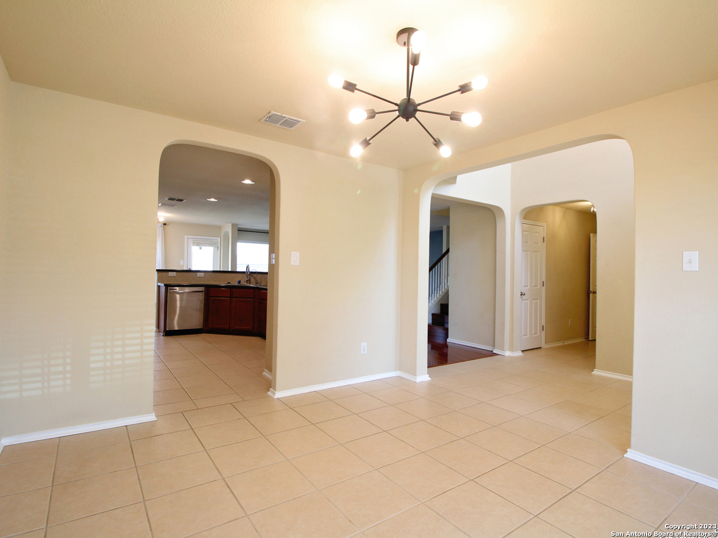 9627 Mediator Run Converse, TX 78109 - Photo 10 of 41 an empty room with fan and kitchen view
