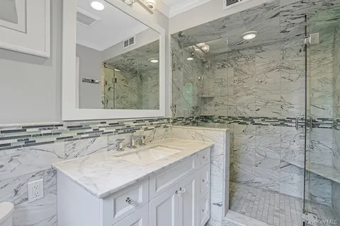 a bathroom with a sink vanity and a mirror
