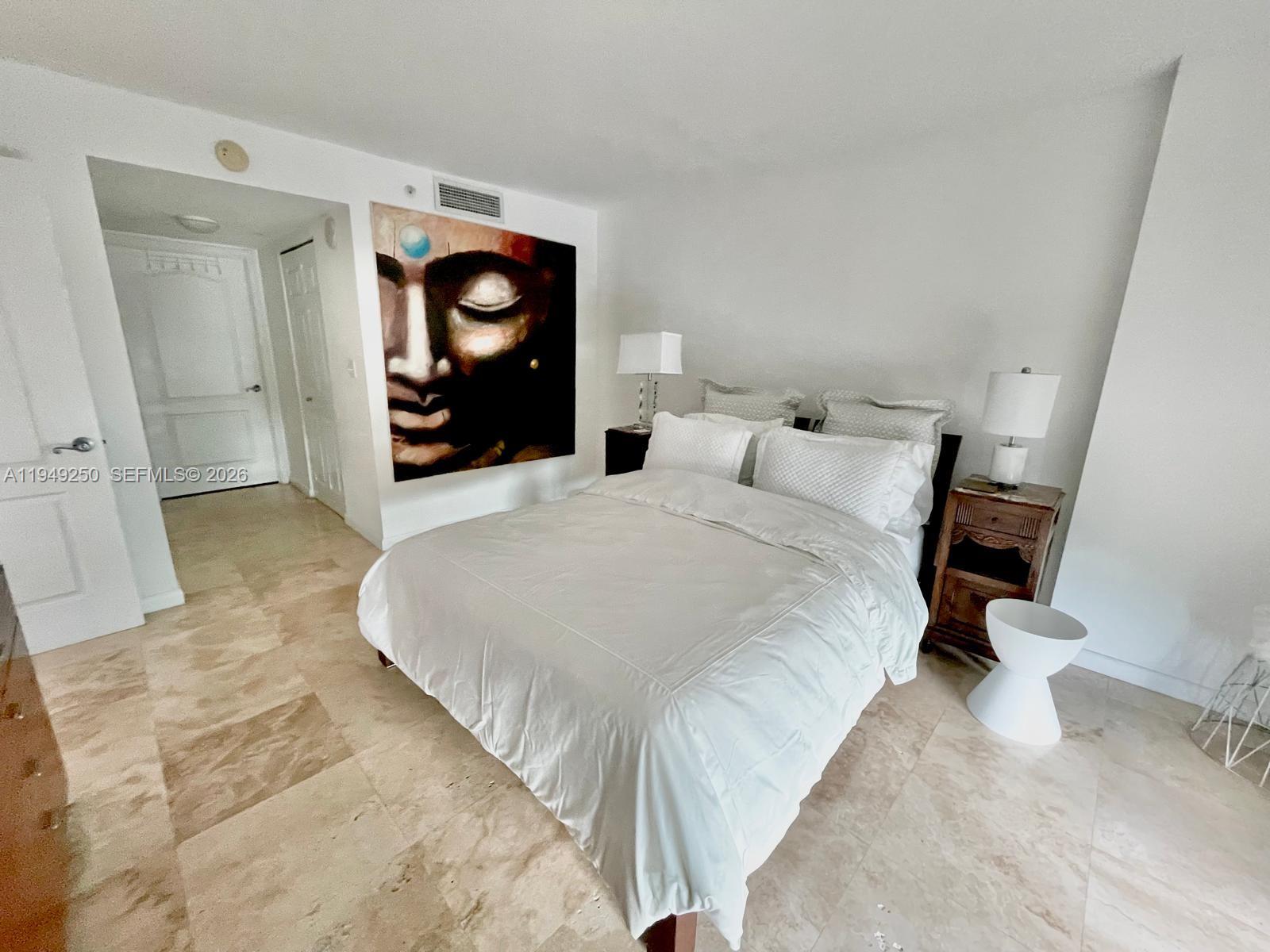 2101 Brickell Avenue, Unit 2110 Miami, FL 33129 - Photo 11 of 15 a bed room with a bed and a mirror
