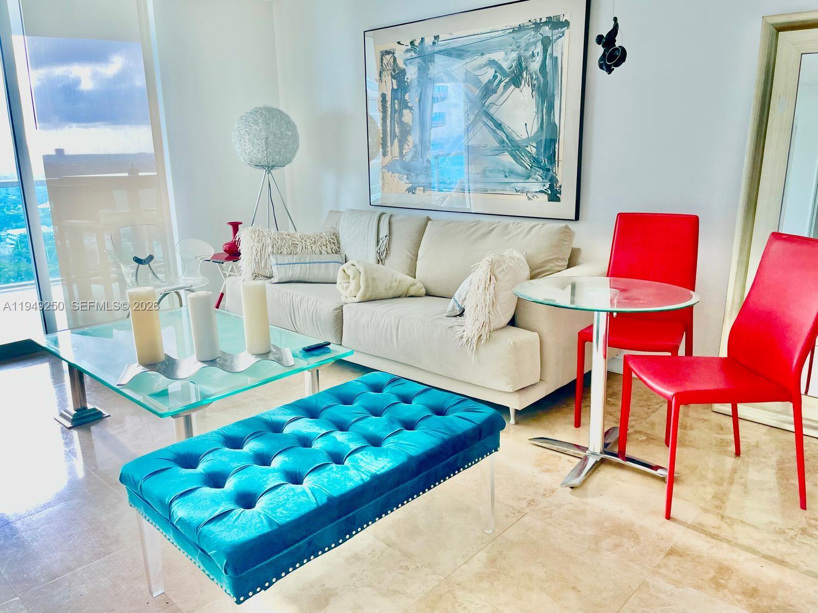 2101 Brickell Avenue, Unit 2110 Miami, FL 33129 - Photo 2 of 15 a living room with furniture and a rug