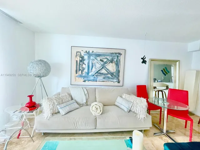 a living room with table and a flat screen tv
