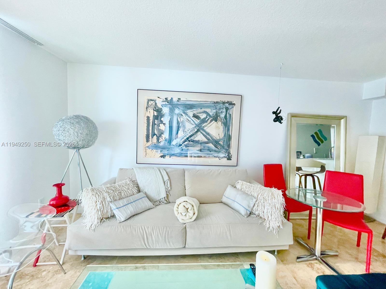 2101 Brickell Avenue, Unit 2110 Miami, FL 33129 - Photo 7 of 15 a living room with furniture and a table