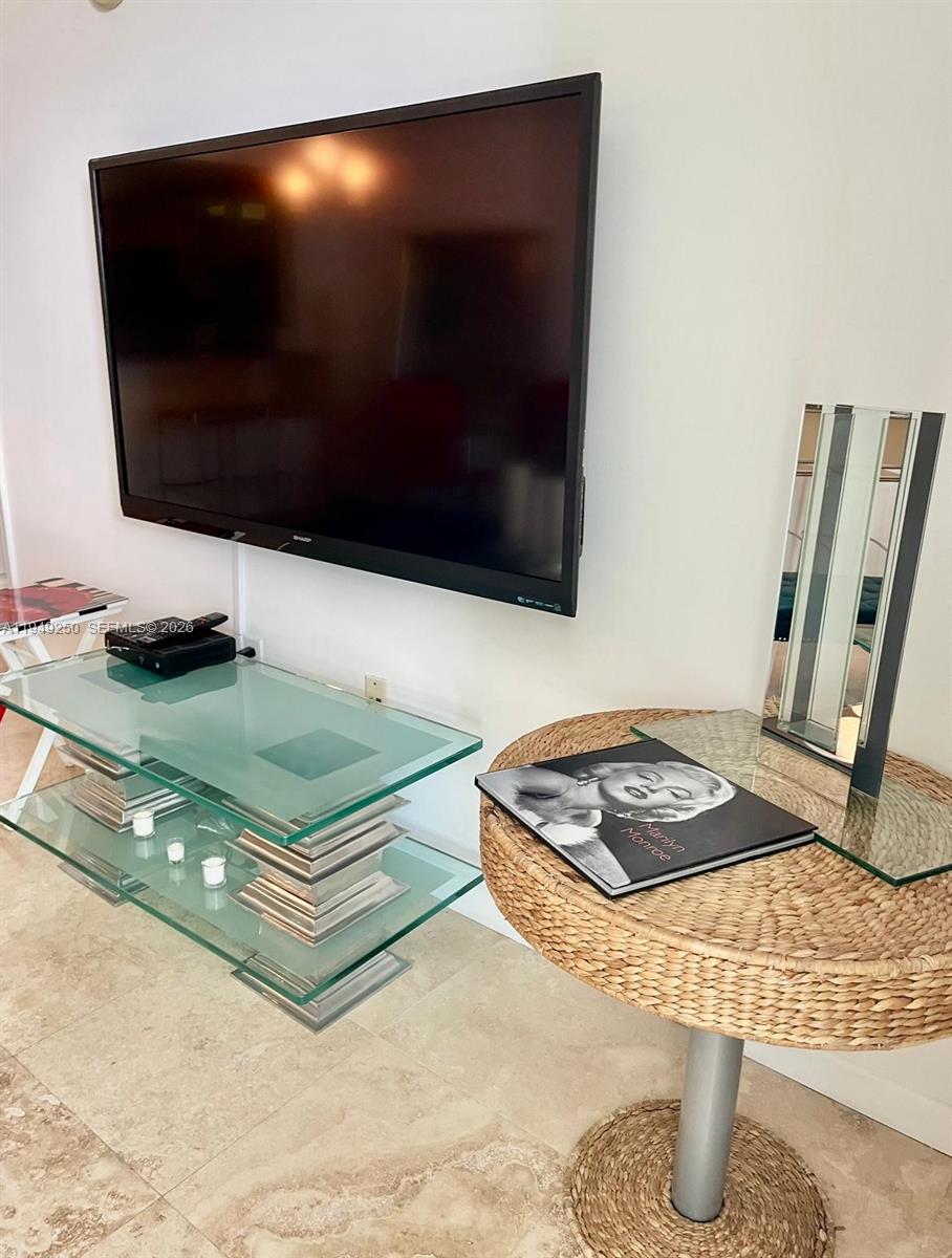 2101 Brickell Avenue, Unit 2110 Miami, FL 33129 - Photo 8 of 15 a living room with table and a flat screen tv