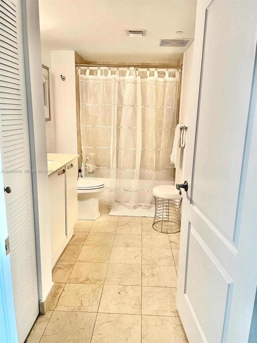 2101 Brickell Avenue, Unit 2110 Miami, FL 33129 - Photo 9 of 15 a bathroom with a bathtub and a shower