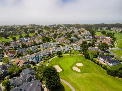 an aerial view of residential houses with outdoor space