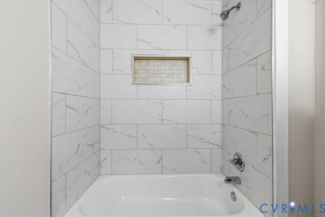 7603 Golf Course Drive Disputanta, VA 23842 - Photo 11 of 24 a bathroom with a bathtub and shower