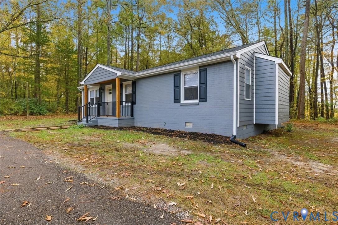7603 Golf Course Drive Disputanta, VA 23842 - Photo 15 of 24 a front view of a house with a yard