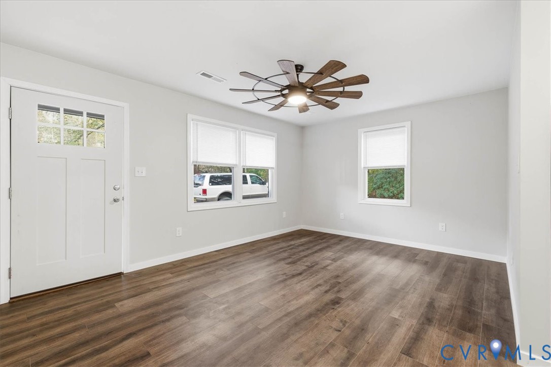 7603 Golf Course Drive Disputanta, VA 23842 - Photo 17 of 24 a view of an empty room with window and wooden floor