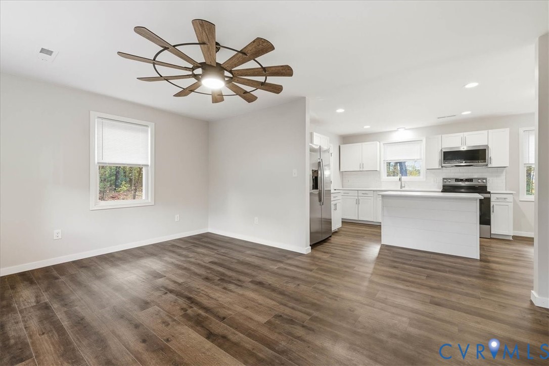 7603 Golf Course Drive Disputanta, VA 23842 - Photo 4 of 24 a view of an empty room with wooden floor and a window