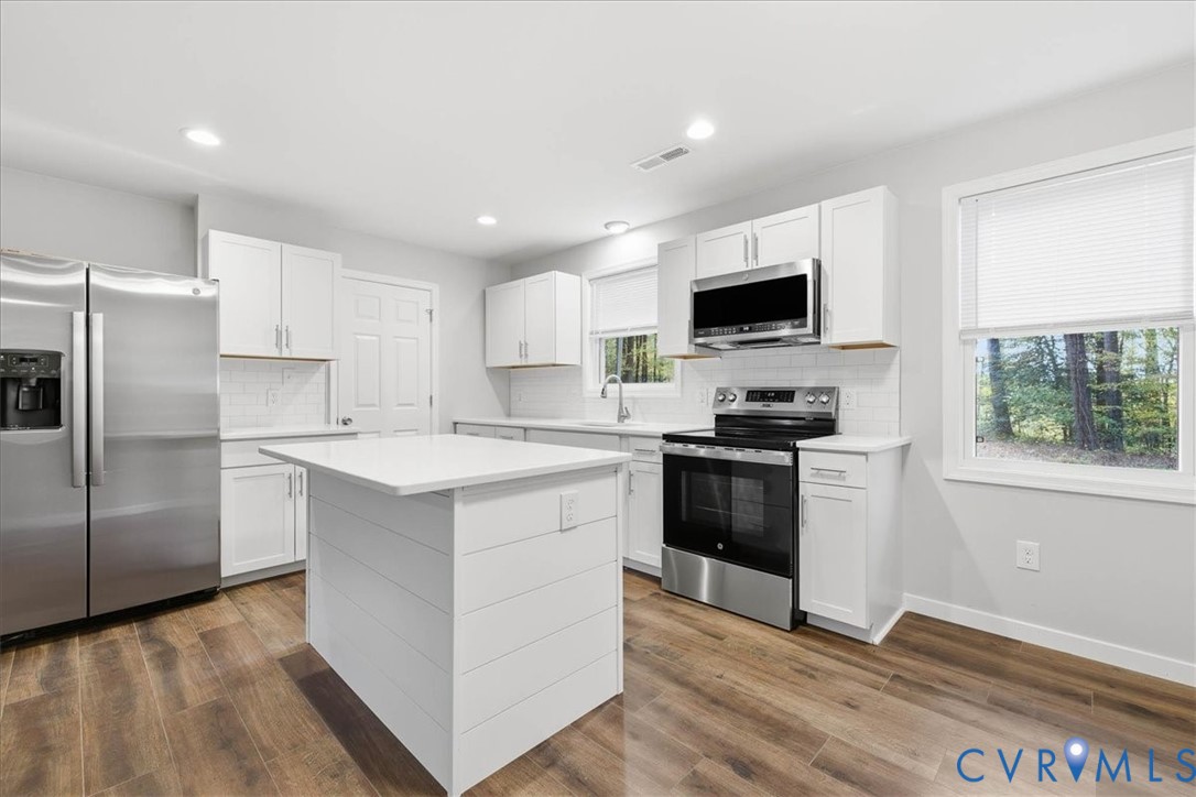 7603 Golf Course Drive Disputanta, VA 23842 - Photo 5 of 24 a kitchen with a refrigerator stove and microwave