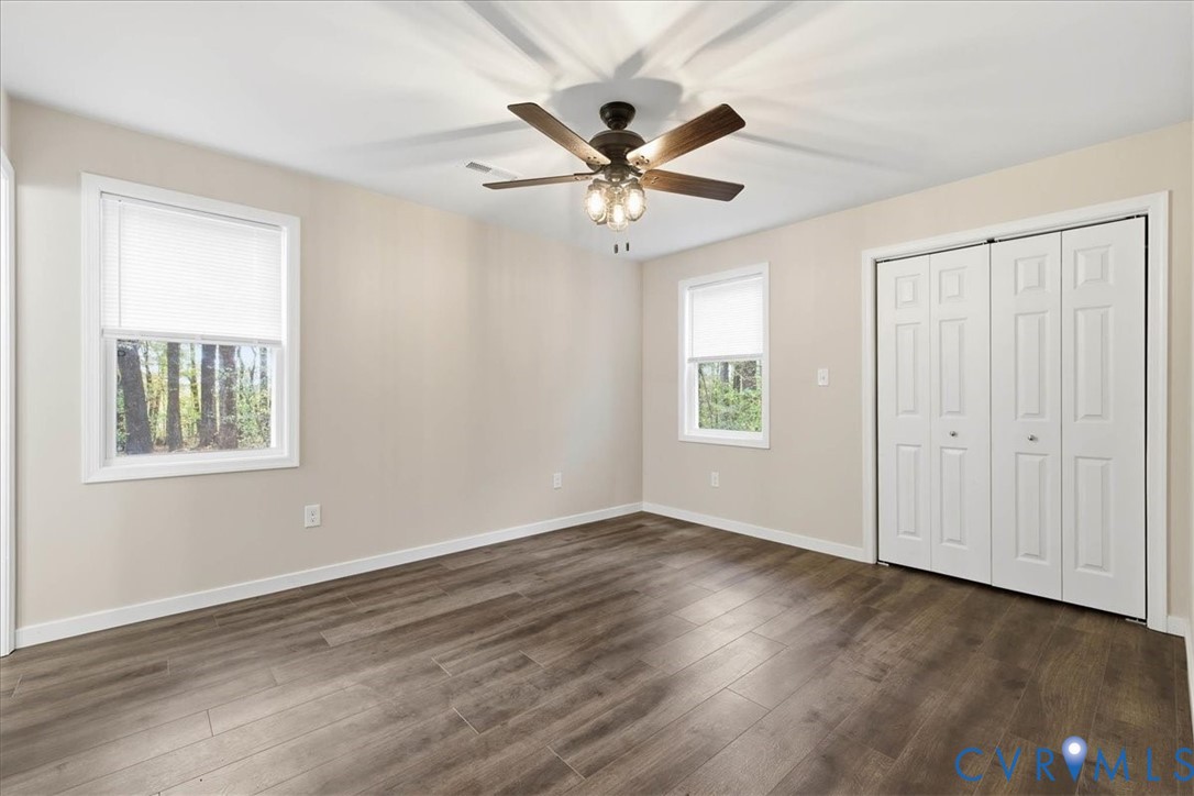 7603 Golf Course Drive Disputanta, VA 23842 - Photo 7 of 24 a view of an empty room with wooden floor and a window
