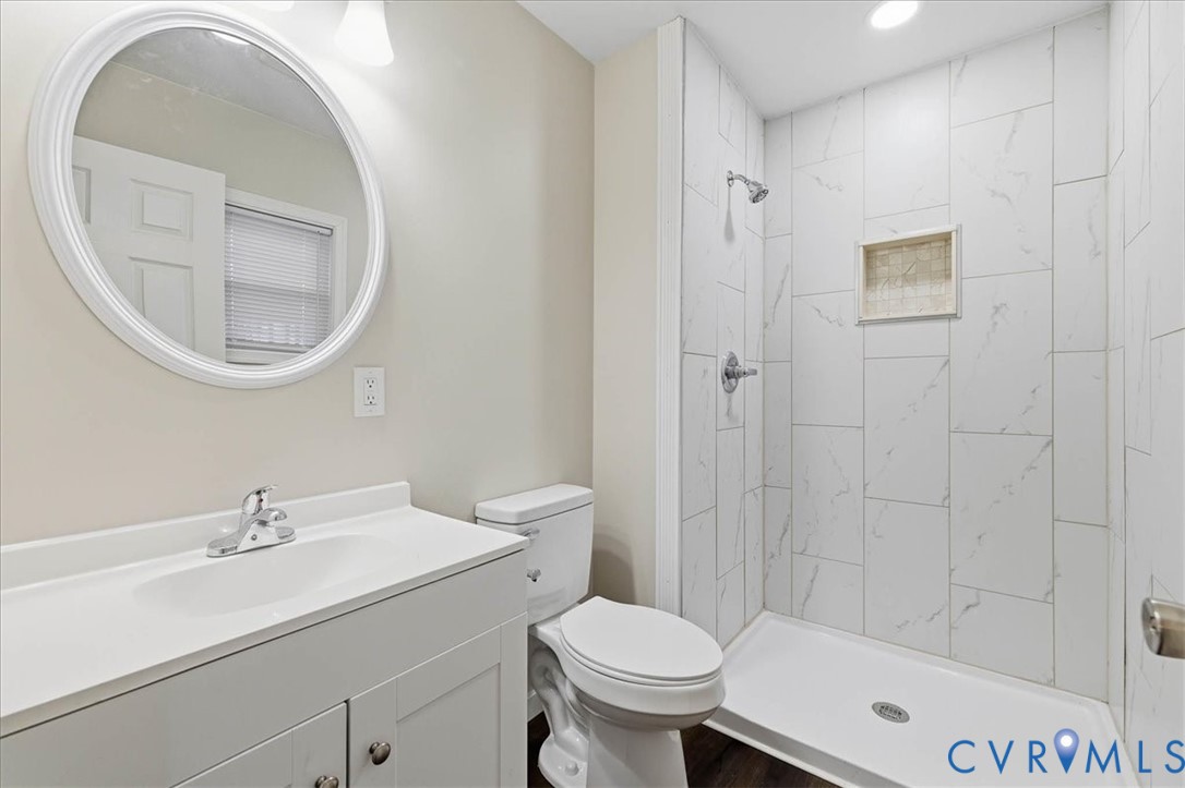 7603 Golf Course Drive Disputanta, VA 23842 - Photo 8 of 24 a bathroom with a sink a toilet and a mirror