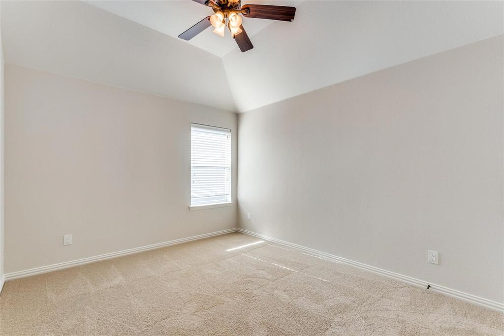 2344 Ranchview Drive Little Elm, TX 75068 - Photo 17 of 24 Room featuring vaulted ceilings, neutral wall tones, textured carpet flooring, a window with horizontal blinds, and a ceiling fan with integrated lighting