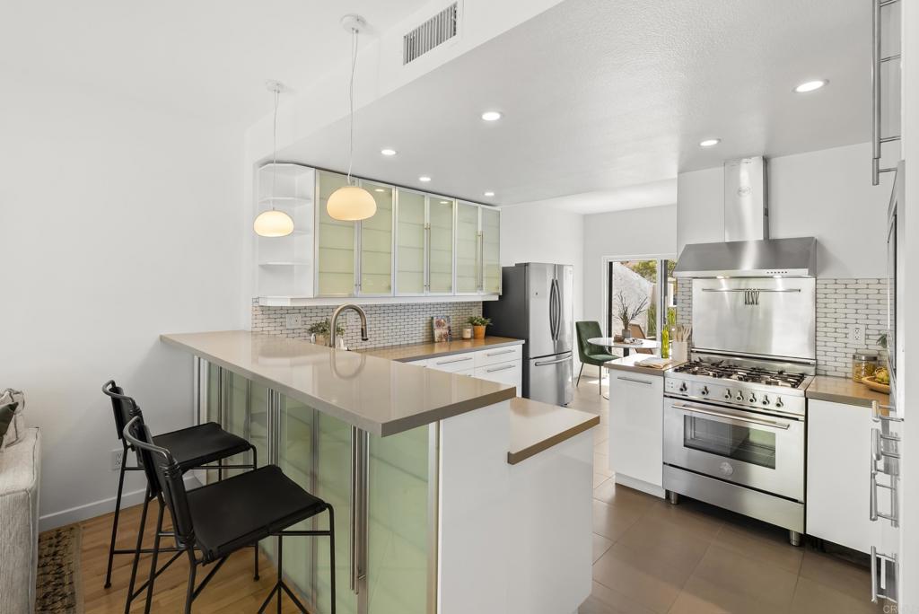 a kitchen with a sink appliances and cabinets