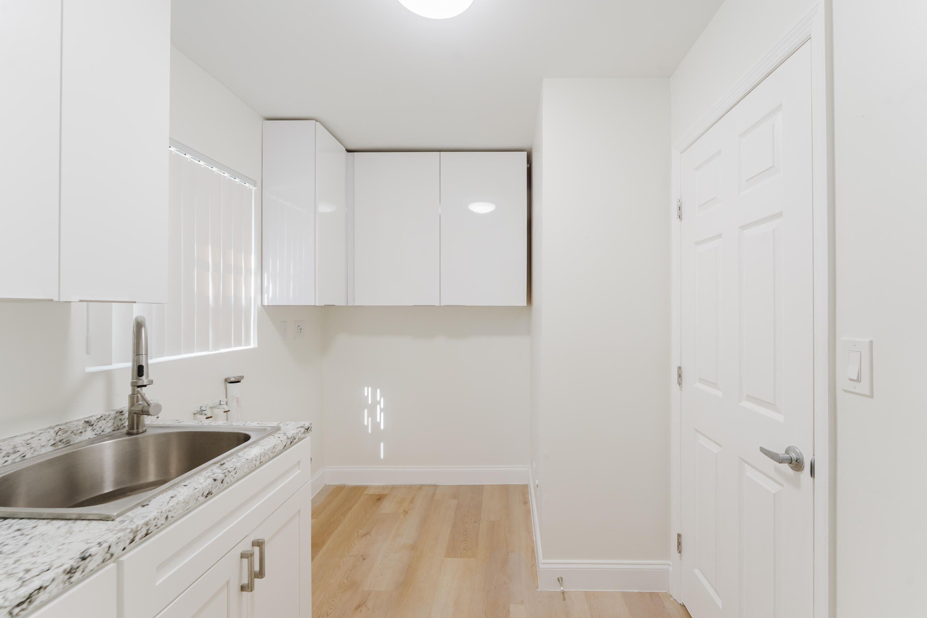 665 Jeffery Street Boca Raton, FL 33487 - Photo 18 of 44 a kitchen with a sink and cabinets