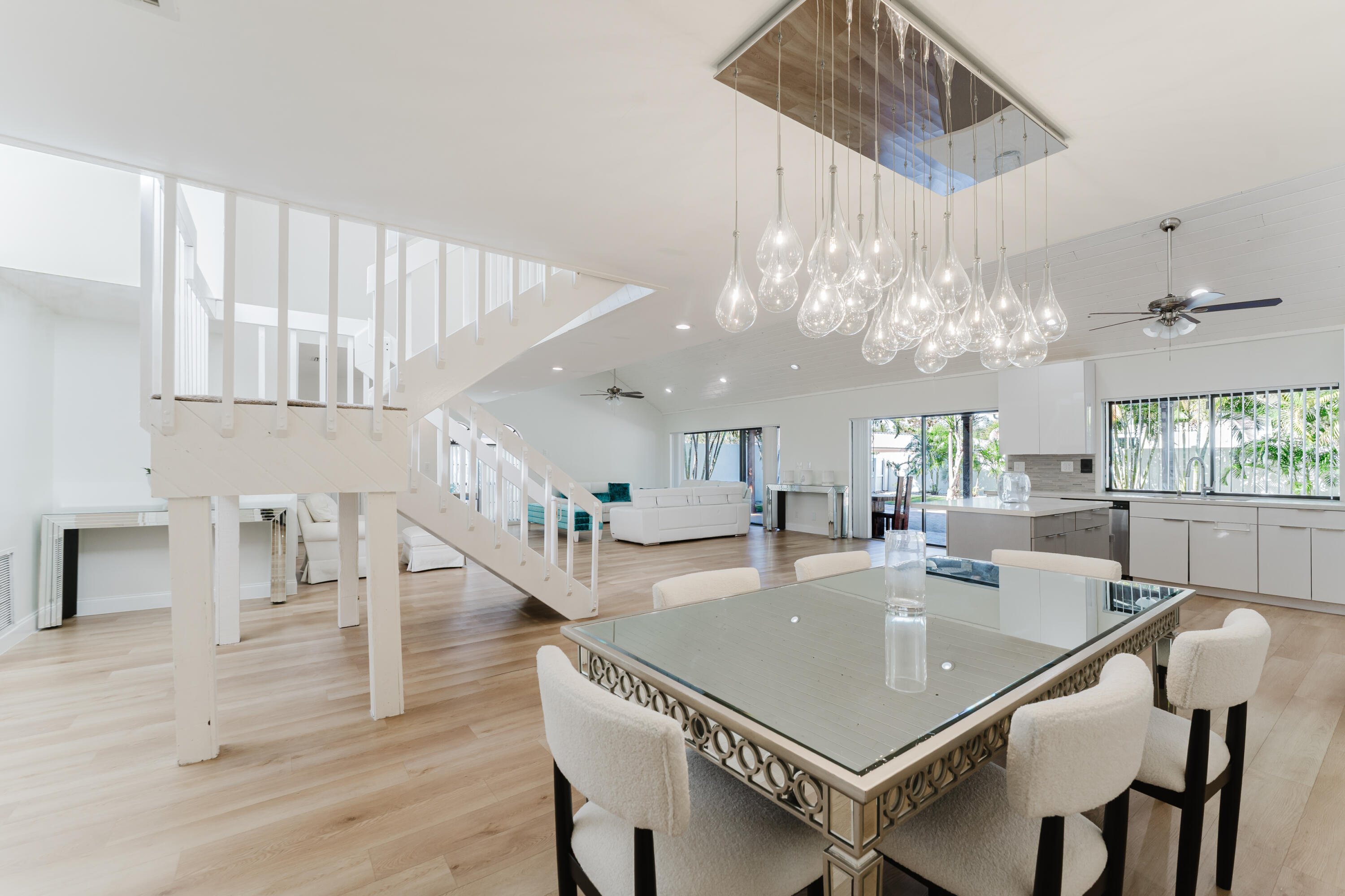 665 Jeffery Street Boca Raton, FL 33487 - Photo 7 of 44 a dining room with wooden floor a chandelier a wooden table and chairs