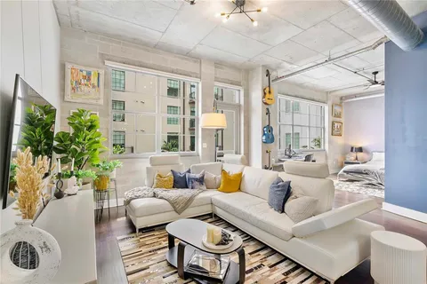 a living room with furniture and a large window