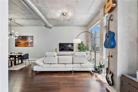a living room with furniture and a flat screen tv