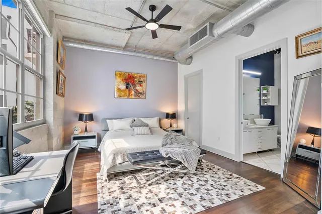 a bedroom with furniture and a rug