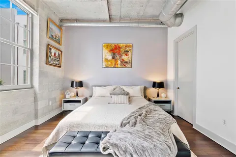 a bedroom with a bed and a night stand