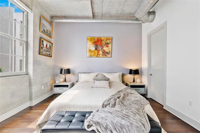 a bedroom with a bed and a night stand