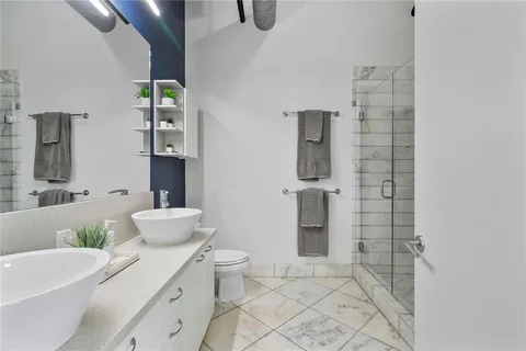 a bathroom with a toilet sink and shower