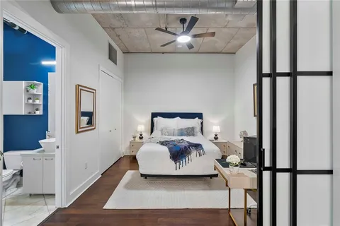 a bedroom with a bed and wooden floor