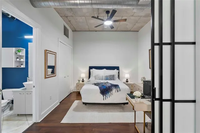 a bedroom with a bed and wooden floor